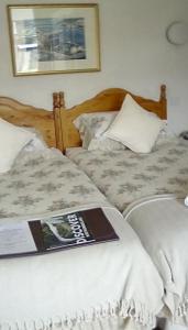 two beds sitting next to each other with a book on them at Aydon House in Alnwick