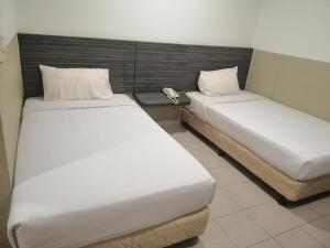 Postel nebo postele na pokoji v ubytování Hotel Orient