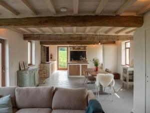 a living room with a couch and a table at Kompas gîte in Ellezelles