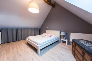 a bedroom with a bed in a attic at le clos du puits in Maslives