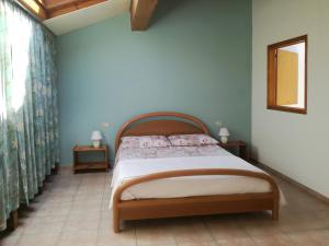 a bedroom with a bed and two tables and a window at Nel Blu in Limido Comasco