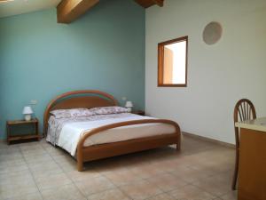 a bedroom with a bed and a table and a window at Nel Blu in Limido Comasco