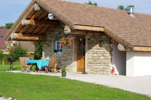 a stone house with a picnic table in front of it at Chambre d'hôtes Chez Karine et Roland in Le Fied