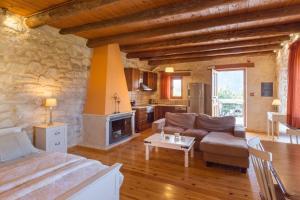 a living room with a couch and a fireplace at Arcus Suites in Argyroupolis