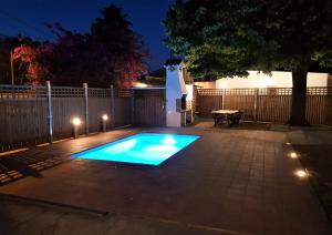 a swimming pool with lights in a backyard at night at Casa Raval De Gracia C in Cambrils