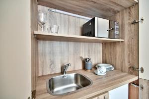 a sink and a cabinet in a small room at The Suites – Piazza Kirkop in Kirkop