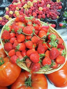 a basket of strawberries and other fruits and vegetables at Maison d'Hôtes Zella in Bains de Guitera