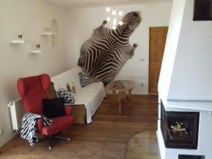 a living room with a zebra head on the wall at Apartmán U Zebry in Bílá Třemešná