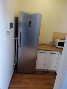 a stainless steel refrigerator in a kitchen next to a counter at Ustecka Przystan in Ustka