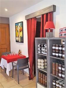 a dining room with a table and a red curtain at Maison d'Hôtes Zella in Bains de Guitera