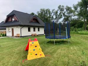 two play equipment in a yard with a house at Villa Detvan in Stará Lesná
