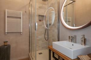 a bathroom with a sink and a shower at One & Only Buonarroti Suite in Rome