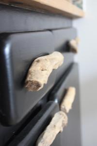 a close up of an oven with two logs at COUP DE COEUR Studio in Rivedoux-Plage
