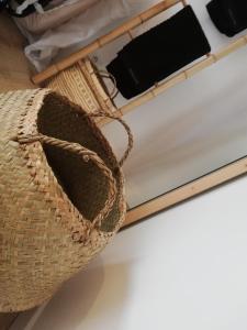 a basket sitting on top of a bed at COUP DE COEUR Studio in Rivedoux-Plage
