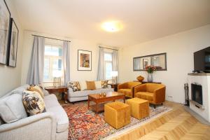 a living room with two couches and a tv at Tallinn City Apartments 4 bedroom with sauna and 2 bathroom in Tallinn