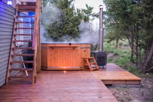 a hot tub on a wooden deck with a ladder at Luige Residence in Reigi