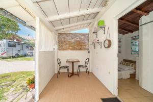 une terrasse avec une table, des chaises et une remorque dans l'établissement Camp Mali bungalow, à Baška