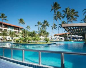 a pool at the resort with palm trees in the background at Flat 2 quartos Resort Marulhos Porto de Galinhas C401 in Porto De Galinhas