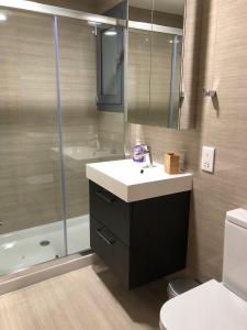 a bathroom with a sink and a shower at Kennedy Deluxe Suites in Nicosia