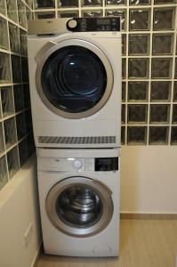 a washer and dryer stacked on top of each other at Kennedy Deluxe Suites in Nicosia