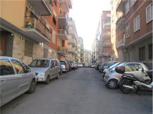 a row of cars parked on a city street at Vatican Mirò Holidays in Rome