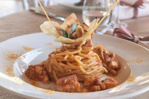 a plate of spaghetti on a white plate at Eliantos Boutique Hotel & Spa in Santa Margherita di Pula