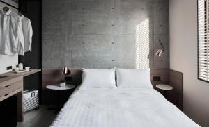 a bedroom with a large white bed in a room at Monka Hotel in Taipei