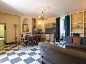 a living room with a couch and a table at Heritage Castle in Chaleix with shared pool in Chaleix