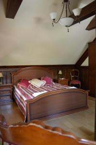 a bedroom with a large wooden bed in a room at Apartment 1925 in Palanga