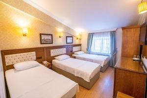 Postelja oz. postelje v sobi nastanitve Assos Kervansaray Hotel - Special Category