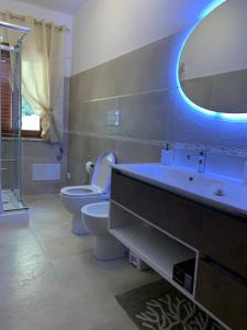 a bathroom with a sink and a toilet and a mirror at Acquamarina in Gaeta