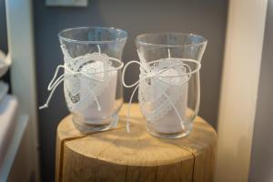 two glasses sitting on top of a wooden table at Villa Brody in Wisła +29 photos