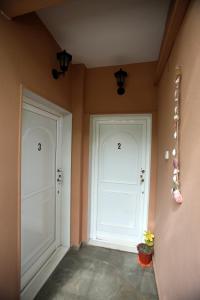 a hallway with two white doors in a room at Pavlidis in Siviri