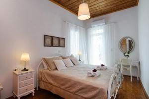 a bedroom with a bed with two teddy bears on it at Diogenis Residence Euphoria in Arménoi