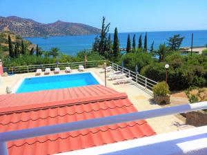 a swimming pool with a view of the ocean at Dimitra Apartments in Agios Nikolaos