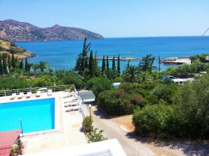 a view of the ocean from a house with a swimming pool at Dimitra Apartments in Agios Nikolaos