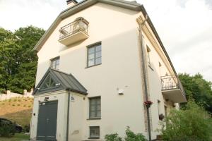 a large white building with a green door at A perfect base to explore Vilnius! in Vilnius