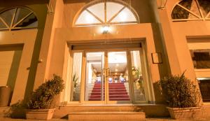 a front door of a building with two potted plants at Atlantic Hotel in Djibouti