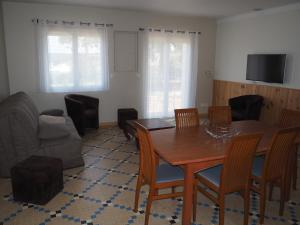 a living room with a table and chairs and a couch at La Maison de l'Ormeau in Montauban