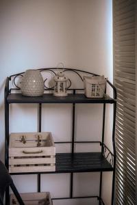 a shelf with a tea kettle and other items on it at Apartment Dream of Split in Split