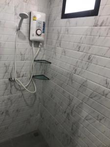 a shower with a soap dispenser in a bathroom at Fine Times Resort in Ko Chang