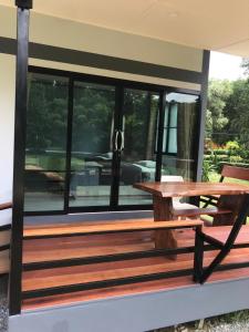 a wooden bench sitting on the side of a house at Fine Times Resort in Ko Chang