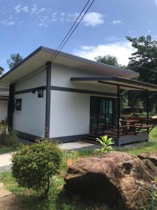 a small white house with a porch at Fine Times Resort in Ko Chang