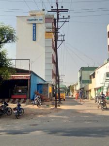 a street with motorcycles parked in front of a building at COMFORT INN in Nāmakkal