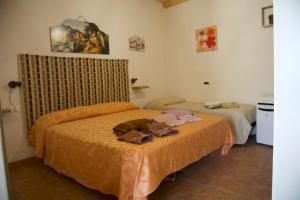 a hotel room with two beds in a room at Casa Vacanza e Camera Fabiola in Castellammare del Golfo