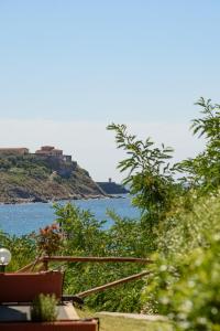 a view of a body of water with a house on a hill at Residence Marina Salivoli in Piombino