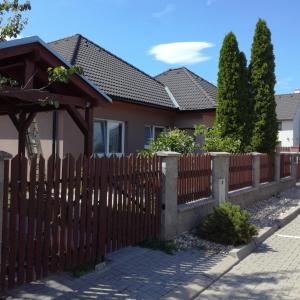 a wooden fence in front of a house at JI APARTMENT crossroads D1,D2,D52 in Modřice
