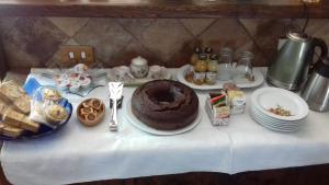 a table with a chocolate cake and plates of food at Le coste in Veroli