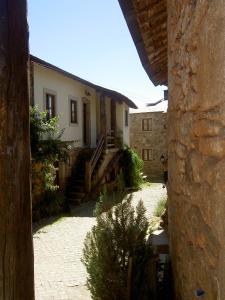 a view of a house from a stone building at A Lagosta Perdida in Montezinho