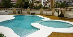 a swimming pool in the middle of a yard at Tortuga Flat in Alicante